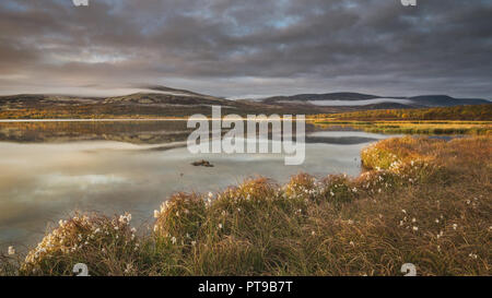 Sunrise time by the Hjerkinnsdammen lake in Dovrefjell-Sunndalsfjella nasional park. Norwegian autumn. Stock Photo