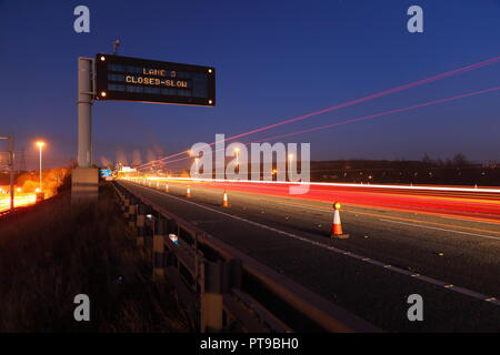 A motorway matrix sign warning motorists of a lane closure due to an incident in the central reservation on the M62 at Pontefract,West Yorkshire,UK Stock Photo