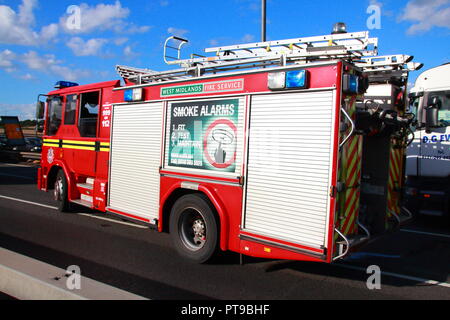 Dennis Fire Engines from West Midlands Fire And Rescue leaving the scene of an accident involving a lorry on the M6 Motorway in Birmingham Stock Photo