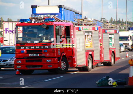 Dennis Fire Engines from West Midlands Fire And Rescue leaving the scene of an accident involving a lorry on the M6 Motorway in Birmingham Stock Photo