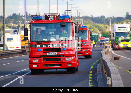 Dennis Fire Engines from West Midlands Fire And Rescue leaving the scene of an accident involving a lorry on the M6 Motorway in Birmingham Stock Photo