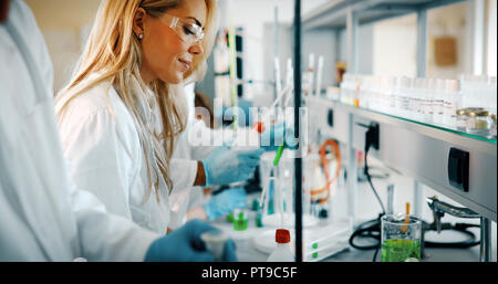 Young students of chemistry working in laboratory Stock Photo