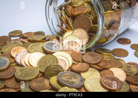 many euro coins in glass on white  save money  change the collect coins Stock Photo