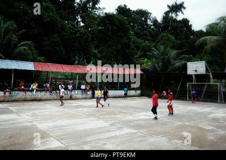 Macedonia, Amazonia / Colombia - MAR 15 2016: local villagers playing football in a remote isolated jungle village Stock Photo
