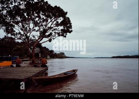 Macedonia, Amazonia / Colombia - MAR 15 2016: local villagers washing and showering at the bank of the river during the evening Stock Photo