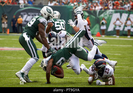 Denver Broncos linebacker Keith Burns jokes with teammates as the