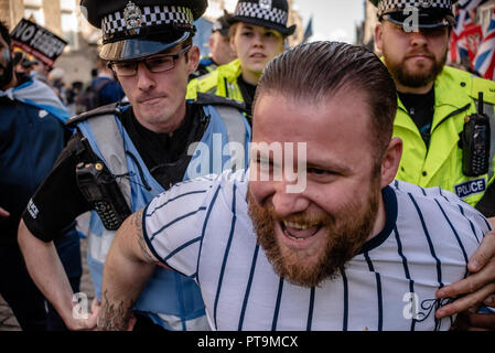 A member of the Pro-Independence side is seen being detained and lead away by members of Police Scotland after trying to rip the Union Jack off of the Pro-Union counter-demo.  Thousands of Scottish independence supporters marched through Edinburgh as part of the ‘all under one banner’ protest, as the coalition aims to run such event until Scotland is ‘free’. Stock Photo