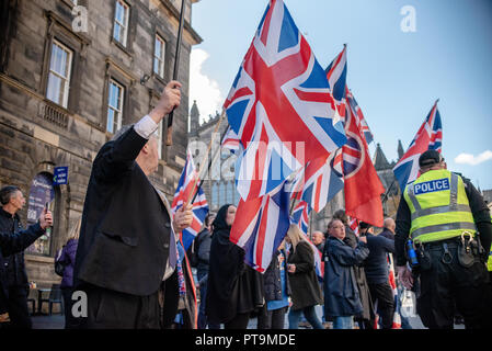 A member of the pro-union side is seen wearing a suit and holding two Union Jacks during the counter-protest.  Thousands of Scottish independence supporters marched through Edinburgh as part of the ‘all under one banner’ protest, as the coalition aims to run such event until Scotland is ‘free’. Stock Photo