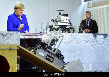 Darmstadt, Hessen, Germany. 08th Oct, 2018. Chancellor Angela Merkel (CDU) visits the Technical University and looks at the journey of a rescue robot. During a demonstration, search and rescue robots from the 'Hector' team are used, which can, for example, search autonomously for buried people. Credit: Uwe Anspach/dpa/Alamy Live News Stock Photo