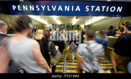 A motion blur of commuters descending down into the bowels of Penn Station during the daily evening rush hour in New York, NY. Stock Photo
