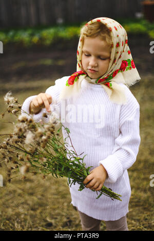 little girl in a headscarf in the field Stock Photo