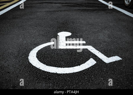 wheel chair sign on asphalt Stock Photo