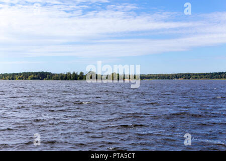 Early autumn. Sunny day. The Volga River near Konakovo. Dense forest on the shore. Tver Region, Central Russia.A background for the site about travel. Stock Photo