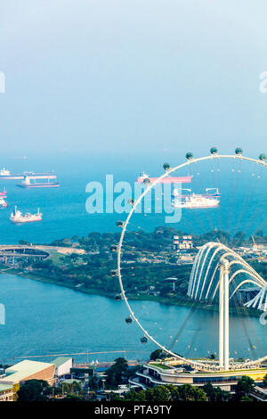 Singapore  - August 18 2018: Aerial view of Singapore sea scape with ships in blue sea featuring Marina Barrage Stock Photo