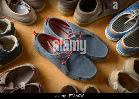 pile of men's shoes on wooden table - closeup Stock Photo