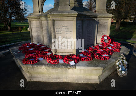 Red poppy wreaths on a war memorial in Chichester, West Sussex, UK. Stock Photo