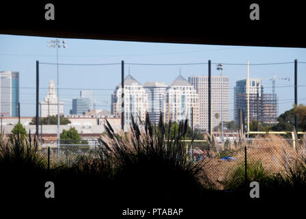 Downtown Oakland photographed from beneath an I-880 overpass in West Oakland, the Ronald V. Dellums Federal Building is centered. Stock Photo