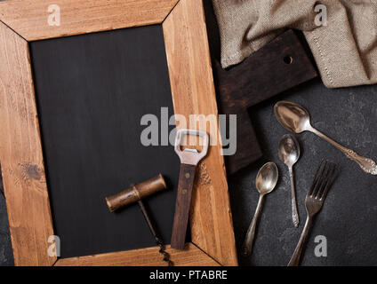 Vintage kitchen wooden utensils with chalk menu board on stone table background. Top view. Stock Photo