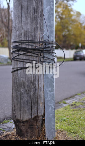 Tangled cables on electric pole on street Stock Photo