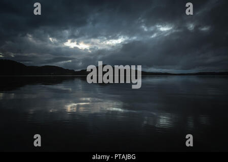 Dark moods after sunset. The night is coming on Jonsvatnet lake. NOrway, Trondheim area. Stock Photo