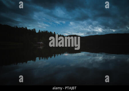 Dark moods after sunset. The night is coming on Jonsvatnet lake. NOrway, Trondheim area. Stock Photo