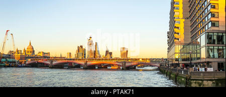 Panoramic skyline view of St Paul's Cathedral and the CIty of London skyscrapers over the River Thames and Blackfriars Bridge looking east Stock Photo