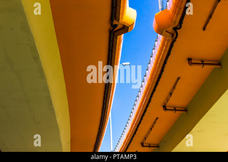 Highway and colored concrete overpasses. Blue sky and metal lantern in the gap. Modern technology in Warsaw, Poland. Stock Photo