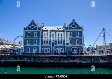 CAPE TOWN, SOUTH AFRICA – 20 MARCH 2018: Beautiful blue and white African Trading Port building at Cape Town's V & A Waterfront against clear blue sky Stock Photo