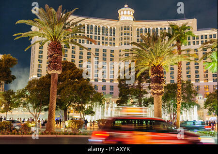 Las Vegas, NV. August, 03 2017. Night shot of The Bellagio Hotel, with a motion blurred car passing in front of it. The Las Vegas Strip is a popular t Stock Photo