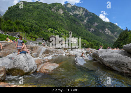 Lavertezzo, Switzerland - 9 June 2018: people sunbathing on the river at Lavertezzo in the Swiss alps Stock Photo
