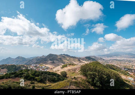 landscape aerial view over valley, hills and village on summer day