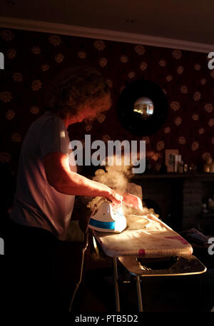 Woman using a Russell Hobbs steam iron Stock Photo