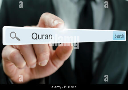 Word Quran written in search bar on virtual screen. Stock Photo