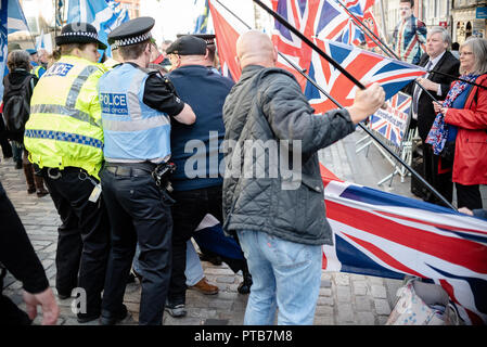 A member of the Pro-Independence side is seen ripping the Union Jack from the railing it was tied too and being detained by officers. Two members of the Pro-Union side are seen trying to stop him.  Thousands of Scottish independence supporters marched through Edinburgh as part of the ‘all under one banner’ protest, as the coalition aims to run such event until Scotland is ‘free’. Stock Photo