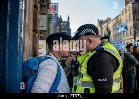 A member of the Pro-Union side is seen during a heated argument with a Police Scotland officer following a near physical altercation with a member of the Pro-Independence side.  Thousands of Scottish independence supporters marched through Edinburgh as part of the ‘all under one banner’ protest, as the coalition aims to run such event until Scotland is ‘free’. Stock Photo