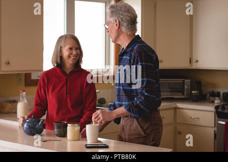 Senior couple interacting with each other while having coffee Stock Photo