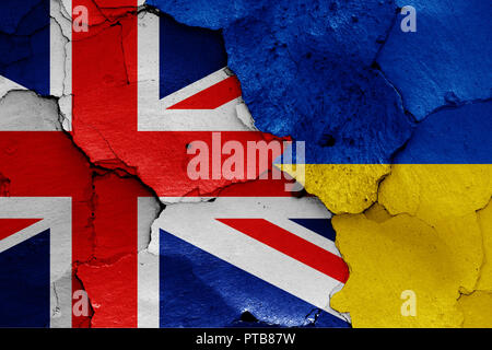flags of UK and Ukraine painted on cracked wall Stock Photo