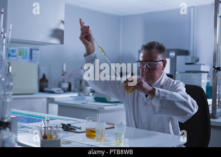 Male scientist experimenting in laboratory Stock Photo