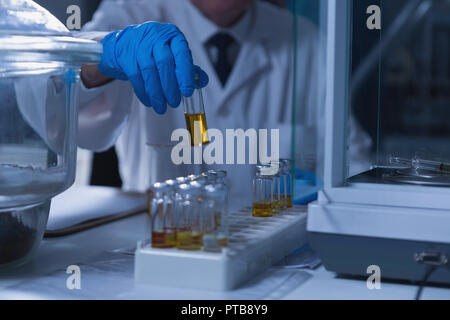 Male scientist experimenting in laboratory Stock Photo