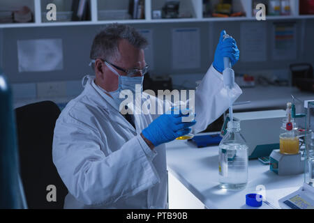 Male scientist experimenting in laboratory Stock Photo