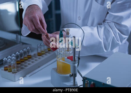 Male scientist experimenting in laboratory Stock Photo