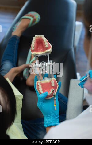 Female dentist explaining about teeth model Stock Photo