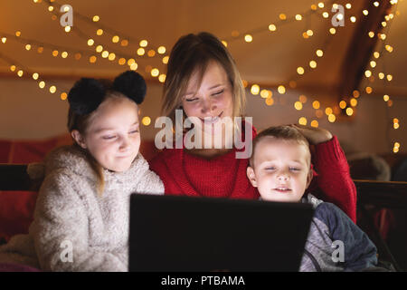 Mother and kids using digital tablet at home Stock Photo