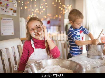 Girl showing a heart shaped cookie cutter Stock Photo
