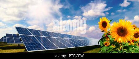 Landscape with photovoltaic plant, sunflowers and cloud sky Stock Photo