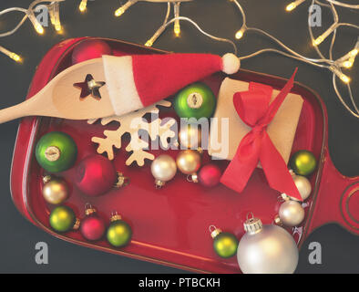Christmas decoration on a plate with cooking spoon and gift box Stock Photo