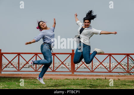 Overweight women jumping in the park. Free space, concept of happy fat women Stock Photo