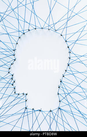 Human head shape made from a large grid of pins connected with string. Communication technology and mental health concept Stock Photo