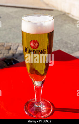 A glass of Binding lager on an outside table, Frankfurt, Hessen, Germany Stock Photo