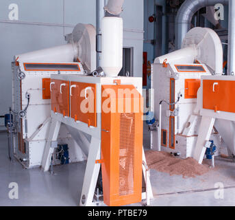 Modern plant for the production of food cereals, a production workshop with equipment for making cereals, the sun, groats Stock Photo